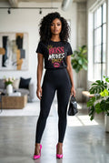 Woman wearing a black t-shirt with text and leggings in a modern indoor setting