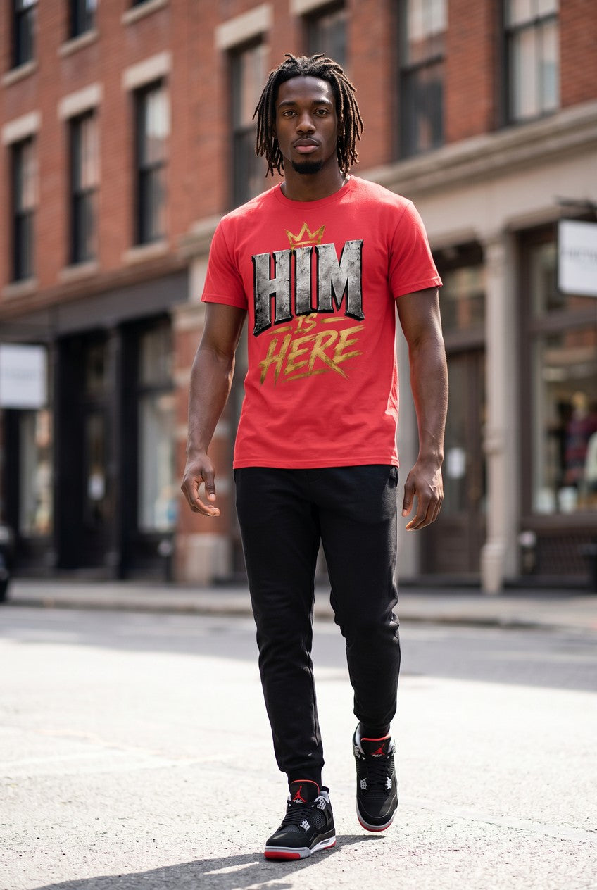 Man wearing a red t-shirt with graphic design walking on a city street.