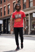 Man wearing a red t-shirt with graphic design walking on a city street.