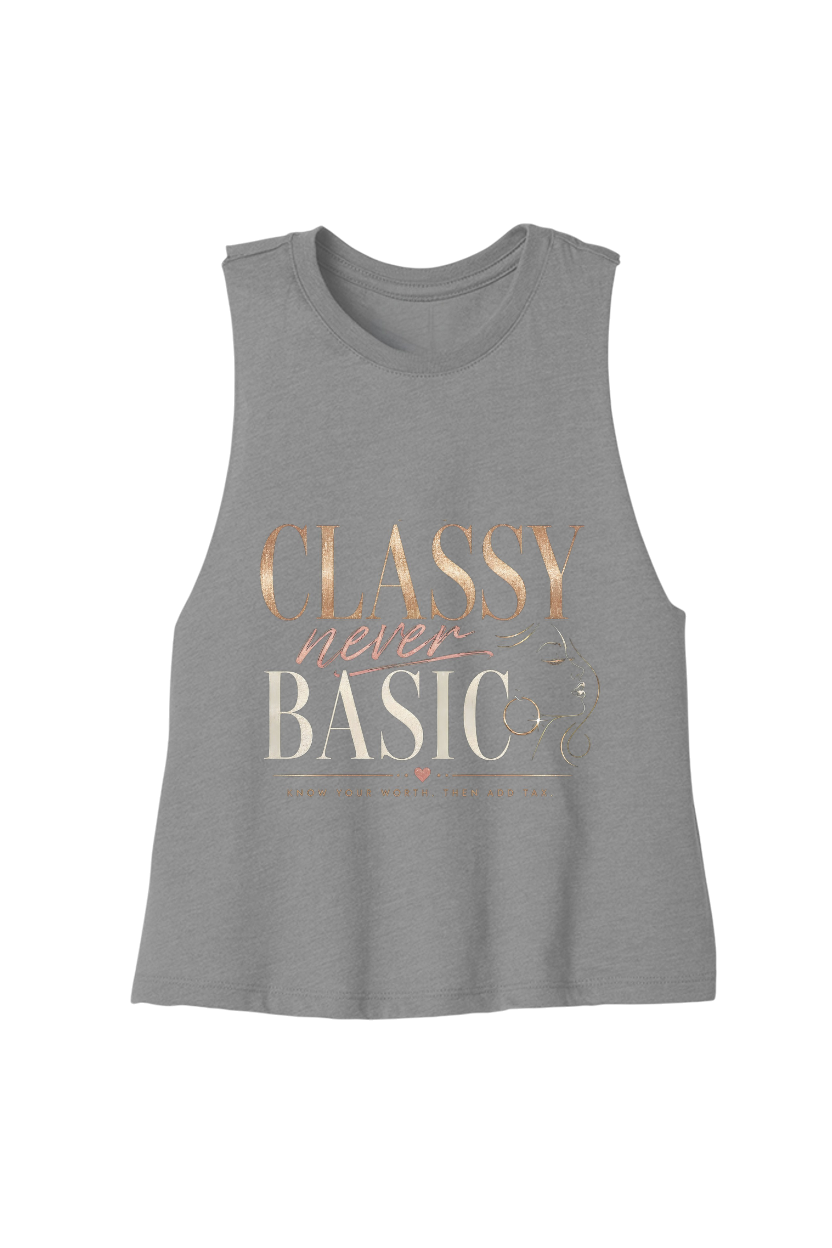 A heather gray sleeveless tank top featuring a retro-style graphic print that reads 'CLASSY never BASIC' in rose gold and cream lettering, displayed against a solid white background.