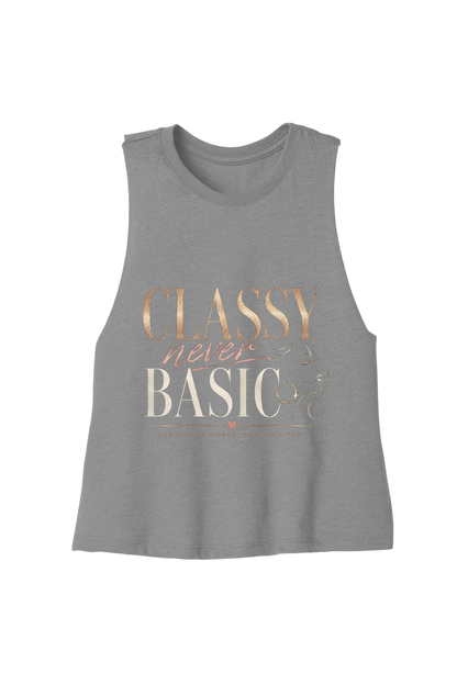 A heather gray sleeveless tank top featuring a retro-style graphic print that reads 'CLASSY never BASIC' in rose gold and cream lettering, displayed against a solid white background.