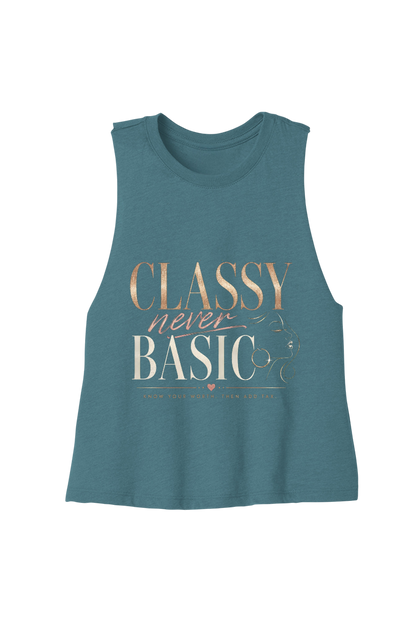 A sleeveless teal muscle tank top with a graphic text print reading 'CLASSY never BASIC' in metallic gold and white lettering, displayed on a solid white background.