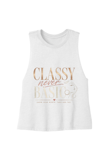 A white sleeveless tank top with a graphic print on the front reading 'CLASSY never BASIC' in rose gold and beige lettering, displayed against a solid white background.
