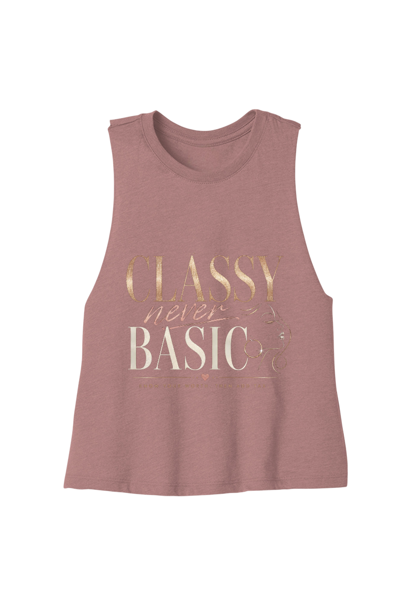 A sleeveless heathered dusty rose muscle tank top featuring a metallic rose gold and cream graphic text print that reads 'CLASSY never BASIC'.