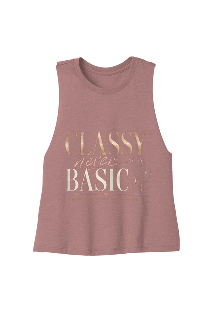 A sleeveless heathered dusty rose muscle tank top featuring a metallic rose gold and cream graphic text print that reads 'CLASSY never BASIC'.