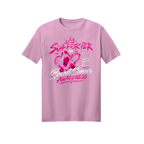 A light pink short-sleeve crewneck t-shirt featuring a pink and silver graphic design on the front that reads 'SUPPORTER of Breast Cancer AWARENESS' with a pink ribbon and crown.