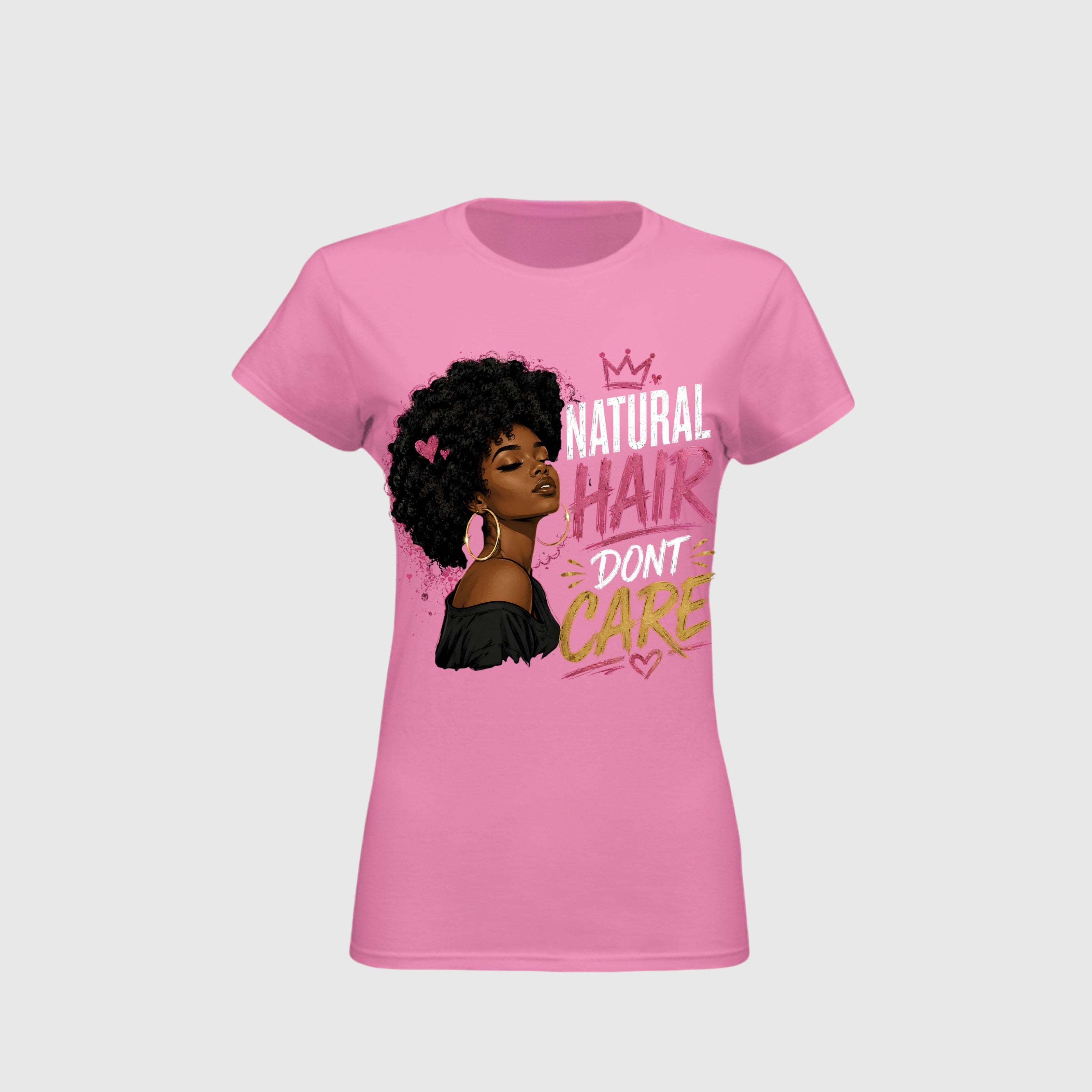 A pink short-sleeve crewneck t-shirt featuring a graphic of a woman with an afro and the text 'NATURAL HAIR DON'T CARE' in white, pink, and gold lettering, displayed on a light gray background.