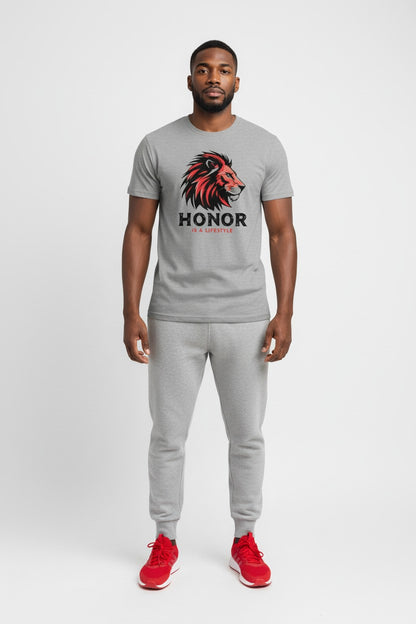 Man wearing a gray t-shirt with a lion graphic and 'Honor' text, paired with gray sweatpants on a white background.
