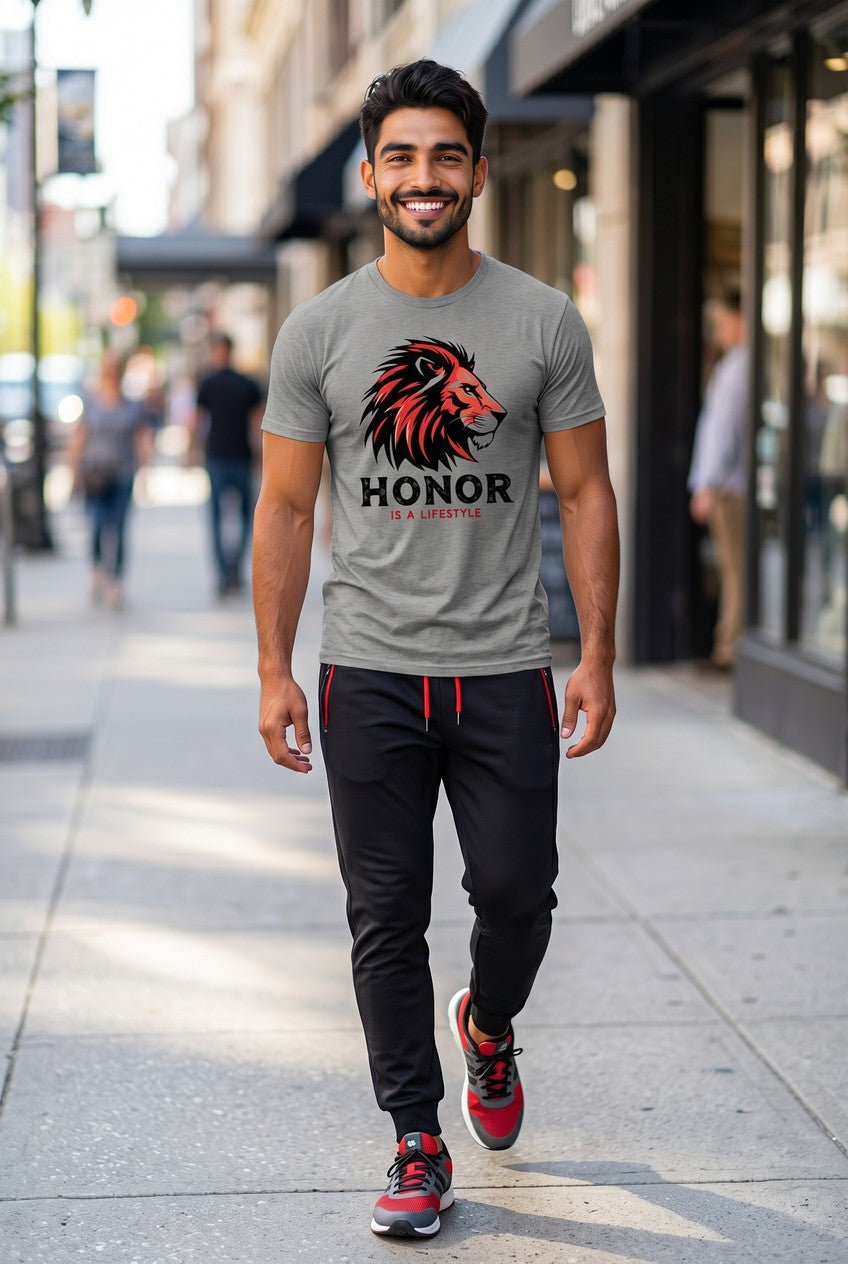 Man walking on a sidewalk wearing a gray t-shirt with a lion graphic and 'Honor' text.