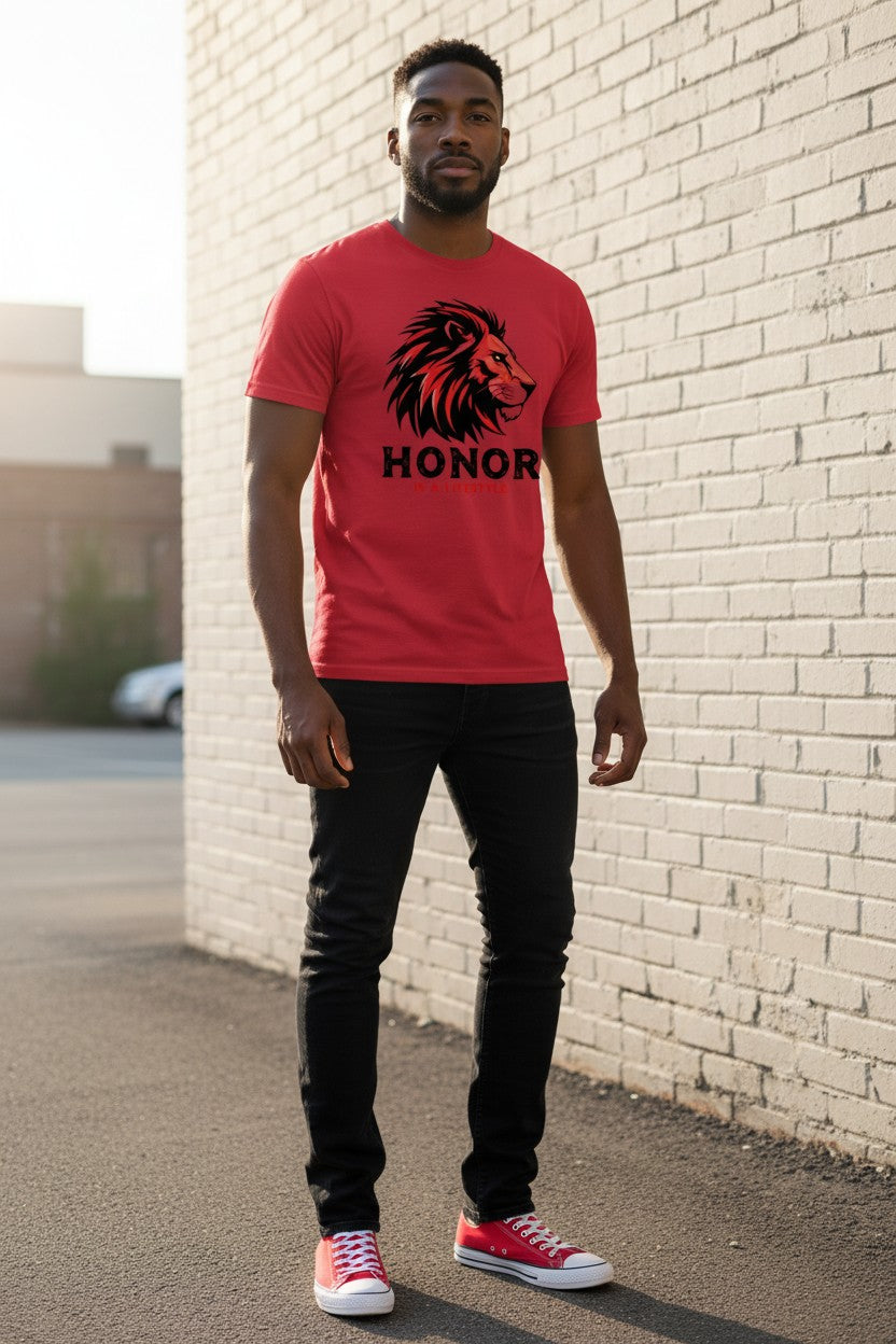 Man wearing a red t-shirt with a lion graphic and 'HONOR' text, standing against a white brick wall.