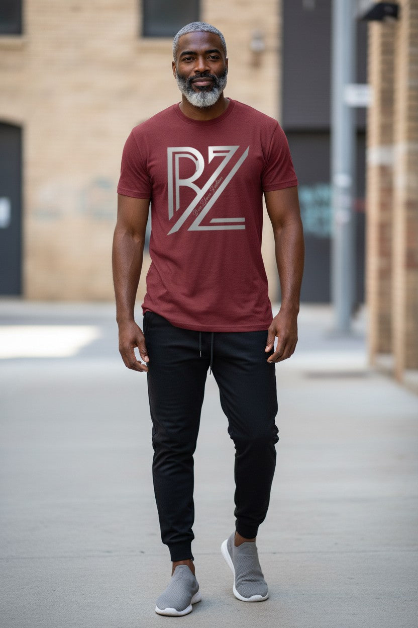 Man wearing a red t-shirt with a logo, standing outdoors.