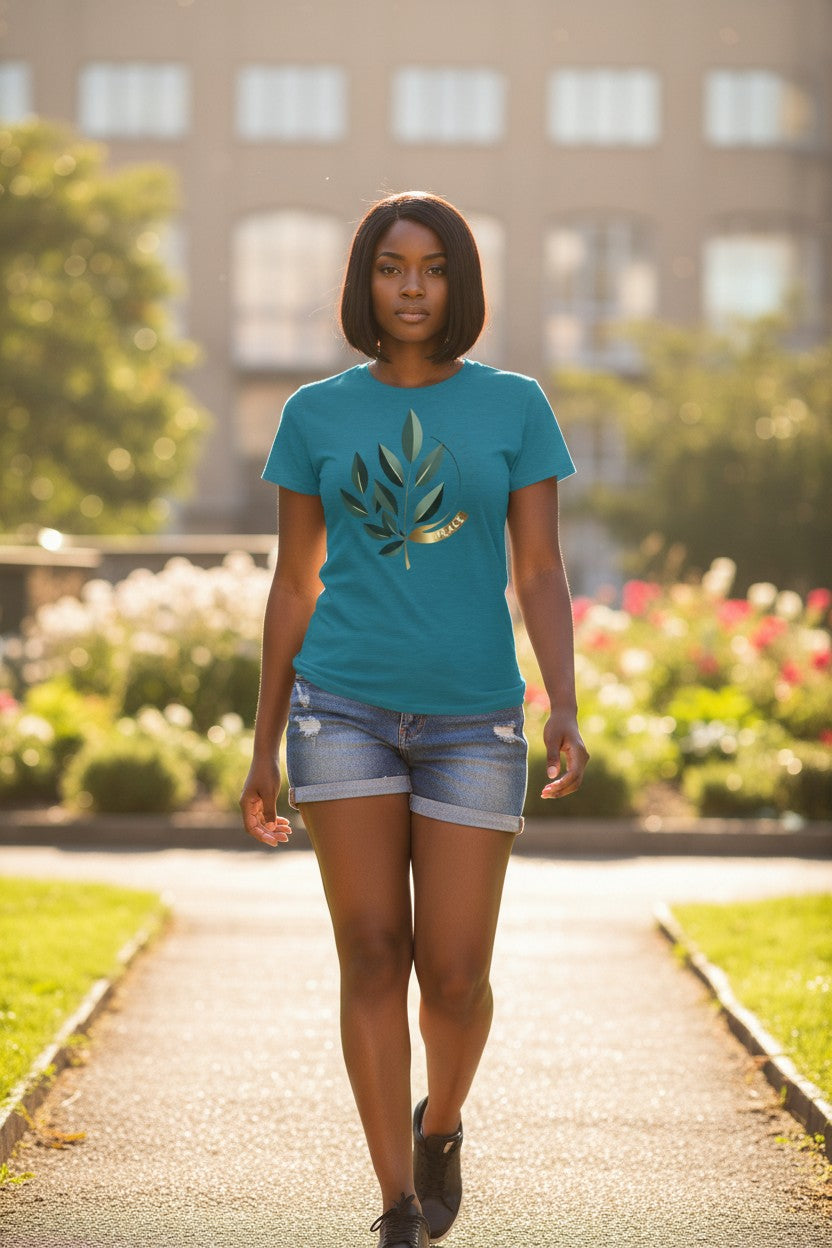 Woman wearing a blue t-shirt with a leaf design in an outdoor setting