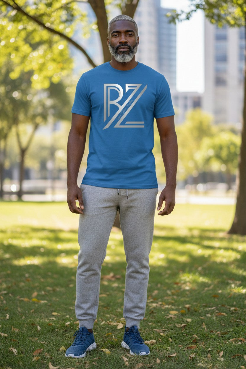 Man wearing a blue t-shirt with a logo in an outdoor setting
