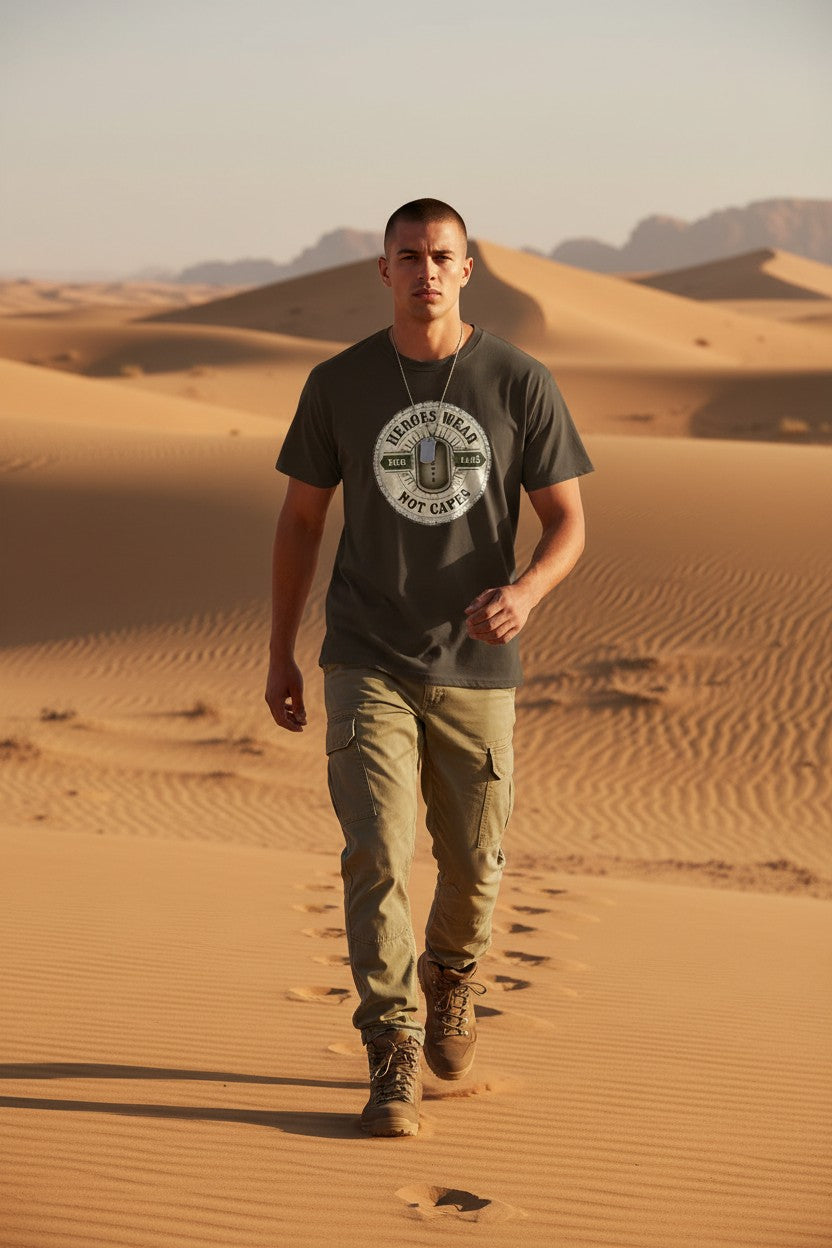 Man walking in the desert wearing a branded t-shirt and boots.