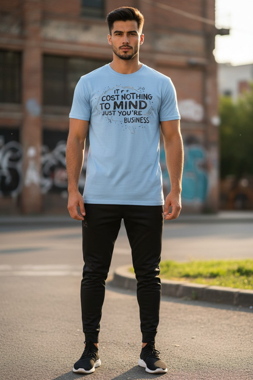 Man wearing a light blue t-shirt with text on it, standing outdoors.