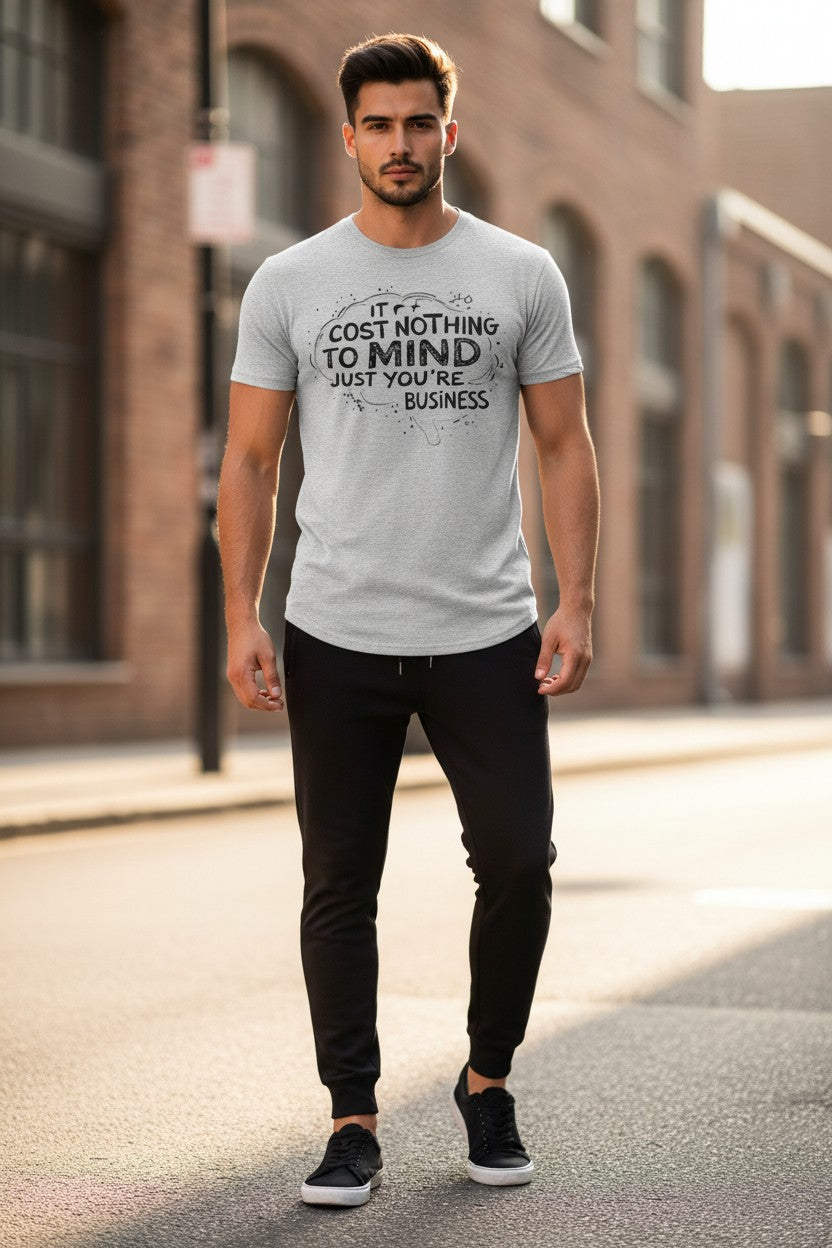 Man wearing a gray t-shirt with text on a street