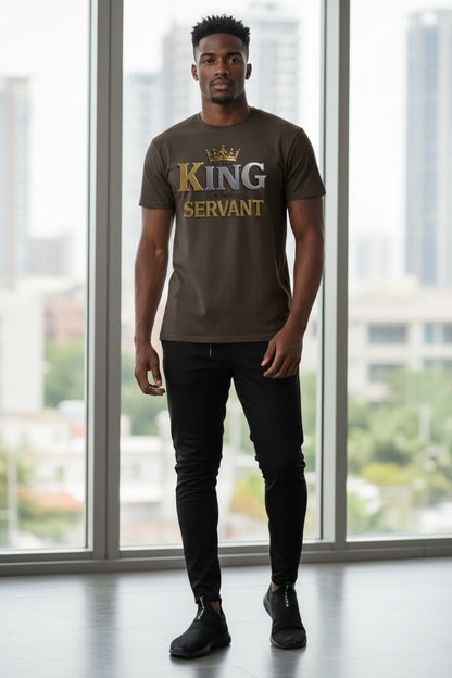 Man wearing a brown t-shirt with 'KING SERVANT' text standing in front of large windows with a cityscape view.
