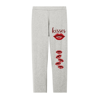 Gray sweatpants with red lip prints and 'kisses' text on a white background
