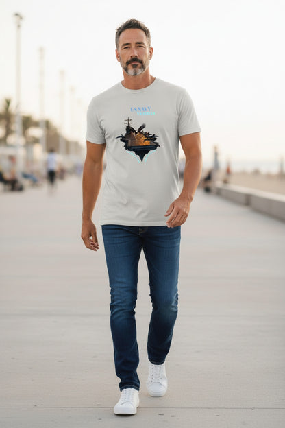 Man walking on a boardwalk wearing a white t-shirt with a graphic design and blue jeans.