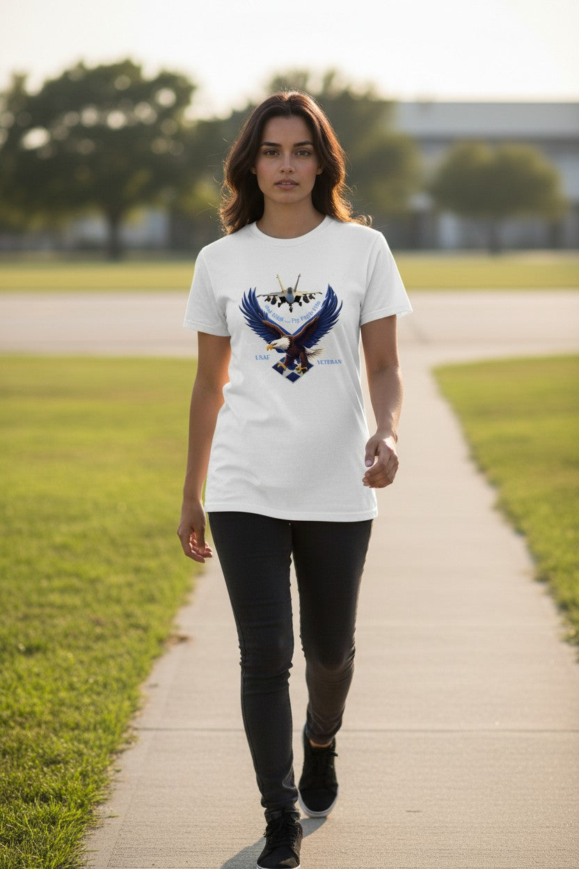 Woman walking on a path in a park wearing a white t-shirt with an eagle design.