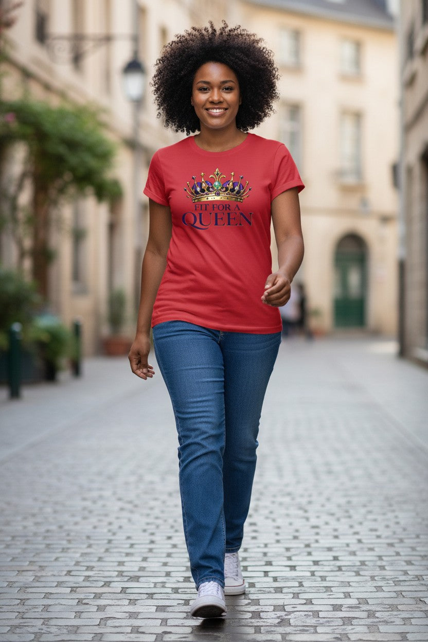 Woman walking down a street wearing a red t-shirt with a graphic design.