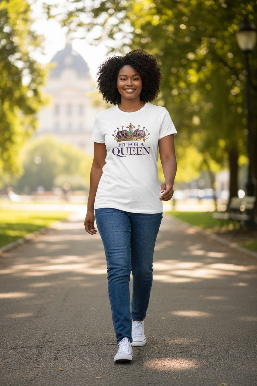 Woman walking outdoors wearing a white t-shirt with 'Fit for a Queen' design.