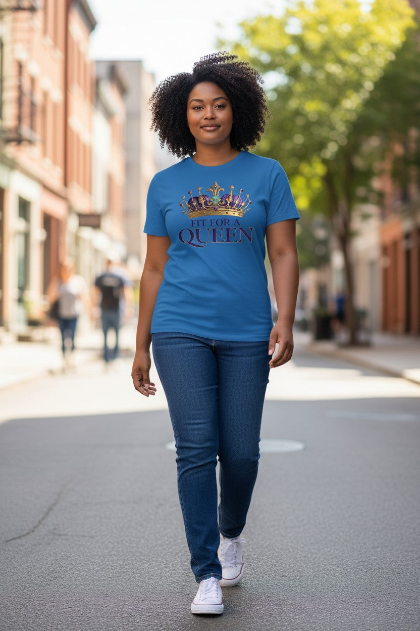 Woman wearing a blue t-shirt with 'Queen' text and crown graphic on a city street.