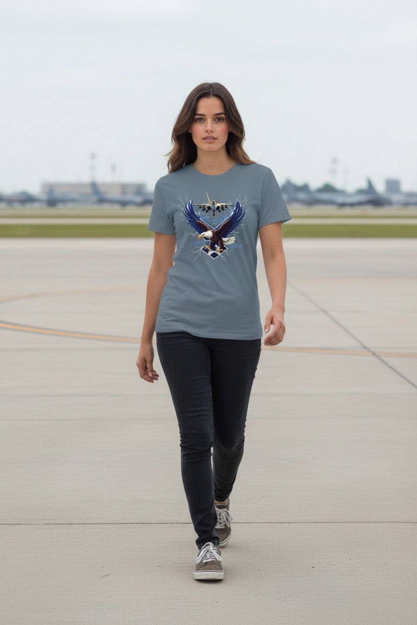 Woman wearing a t-shirt with an eagle design on an airport runway.
