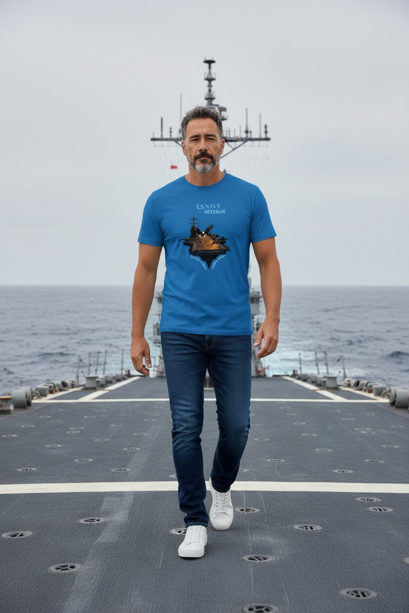 Man wearing a blue t-shirt with a graphic design on a ship deck.