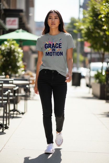 Woman walking on a sidewalk wearing a gray t-shirt with 'Grace in Motion' text.