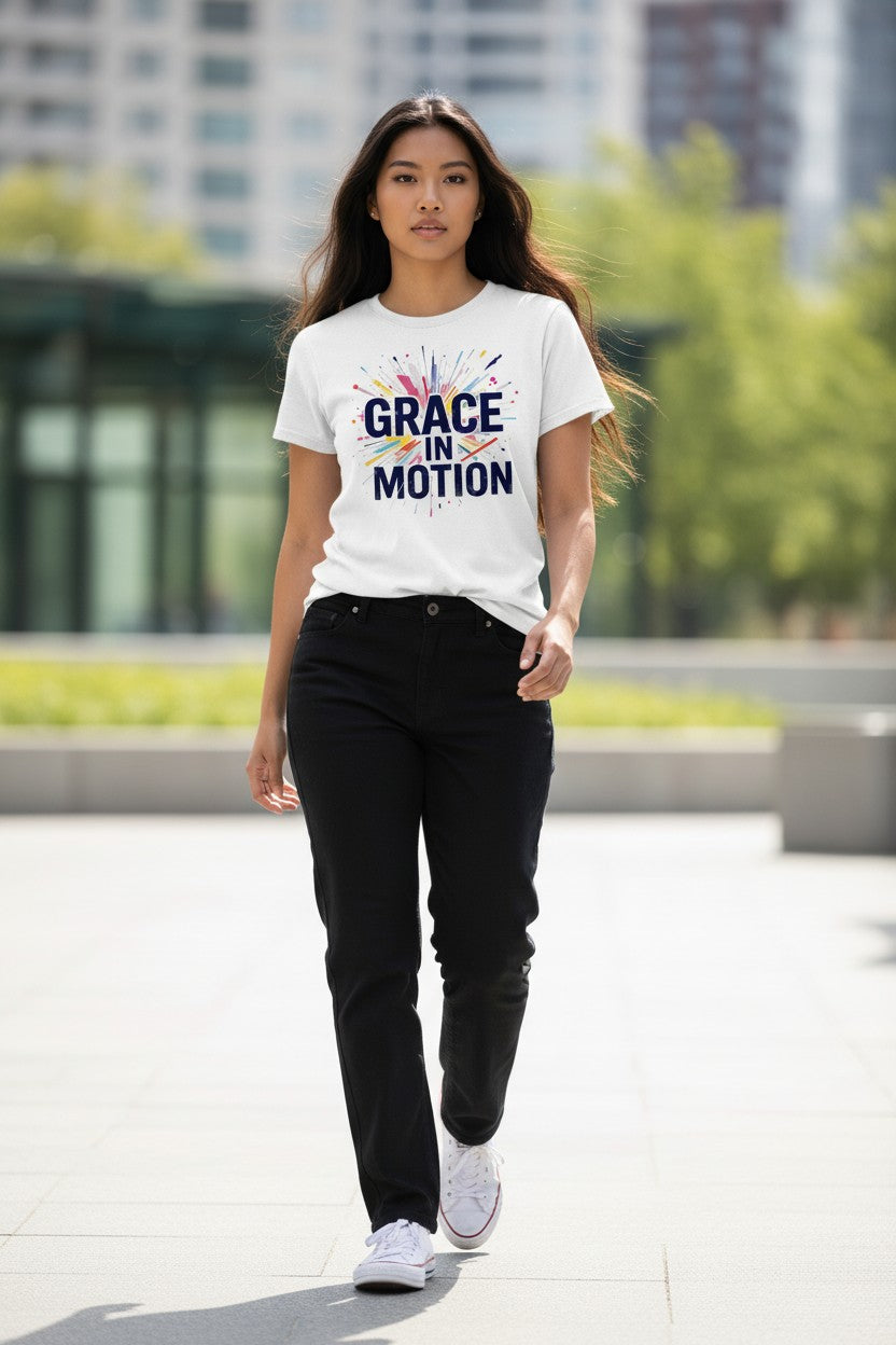 Woman wearing a white t-shirt with 'Grace in Motion' text, walking outdoors.