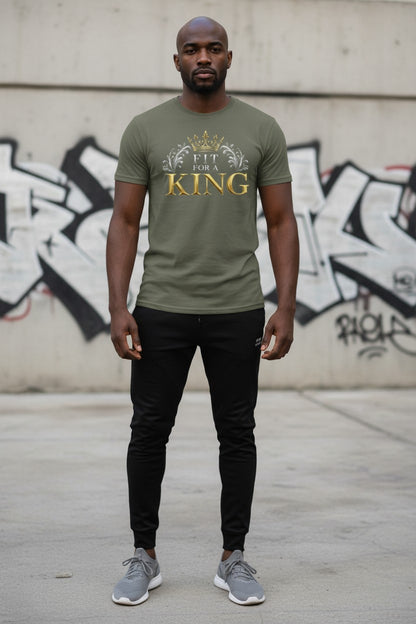 Man wearing a green t-shirt with 'King' printed on it, standing in front of a graffiti-covered wall.