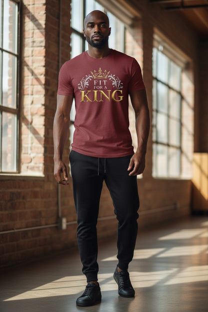 Man wearing a red t-shirt with 'Fit for a King' text in a sunlit room.