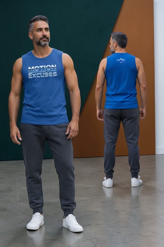 Man wearing a blue tank top with text, standing in front of a colorful wall.