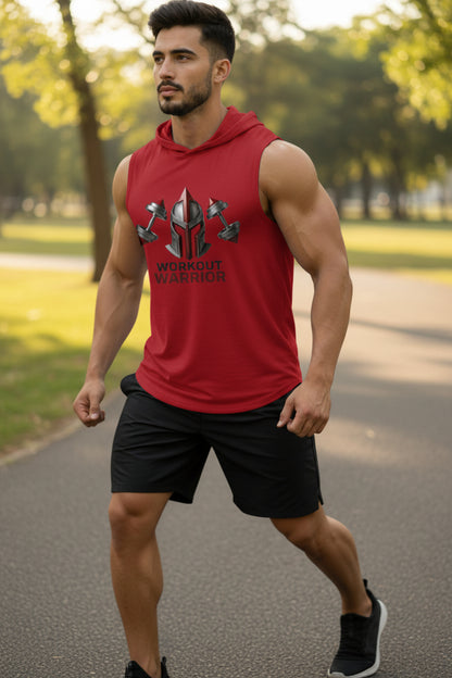 Man wearing a red sleeveless shirt with a logo and text, standing outdoors on a path.