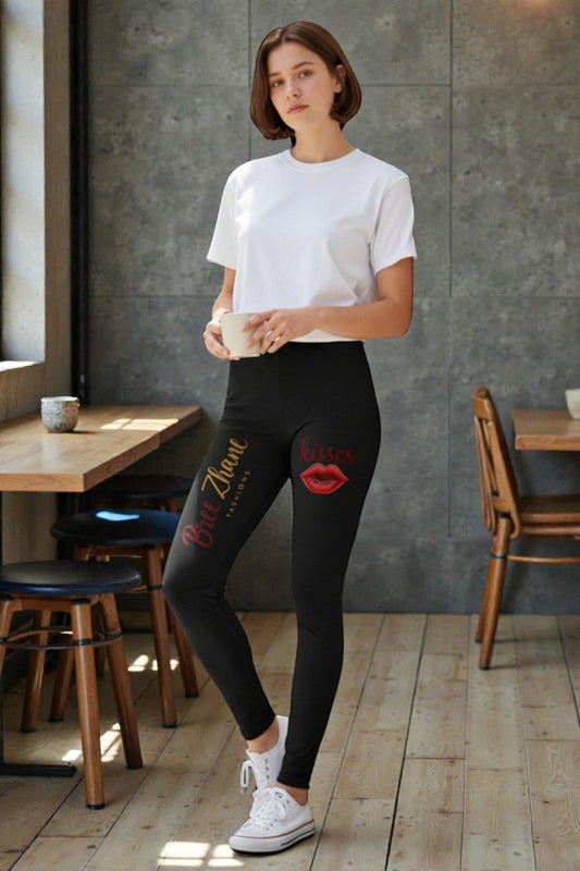 Woman wearing a white t-shirt and black leggings with designs in a casual setting.